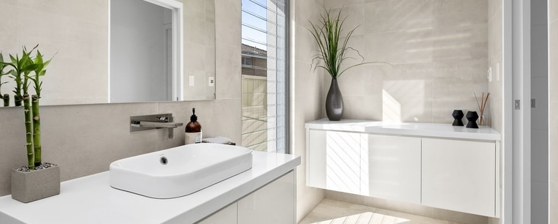 white ceasar stone with concrete look tiles powder room reno